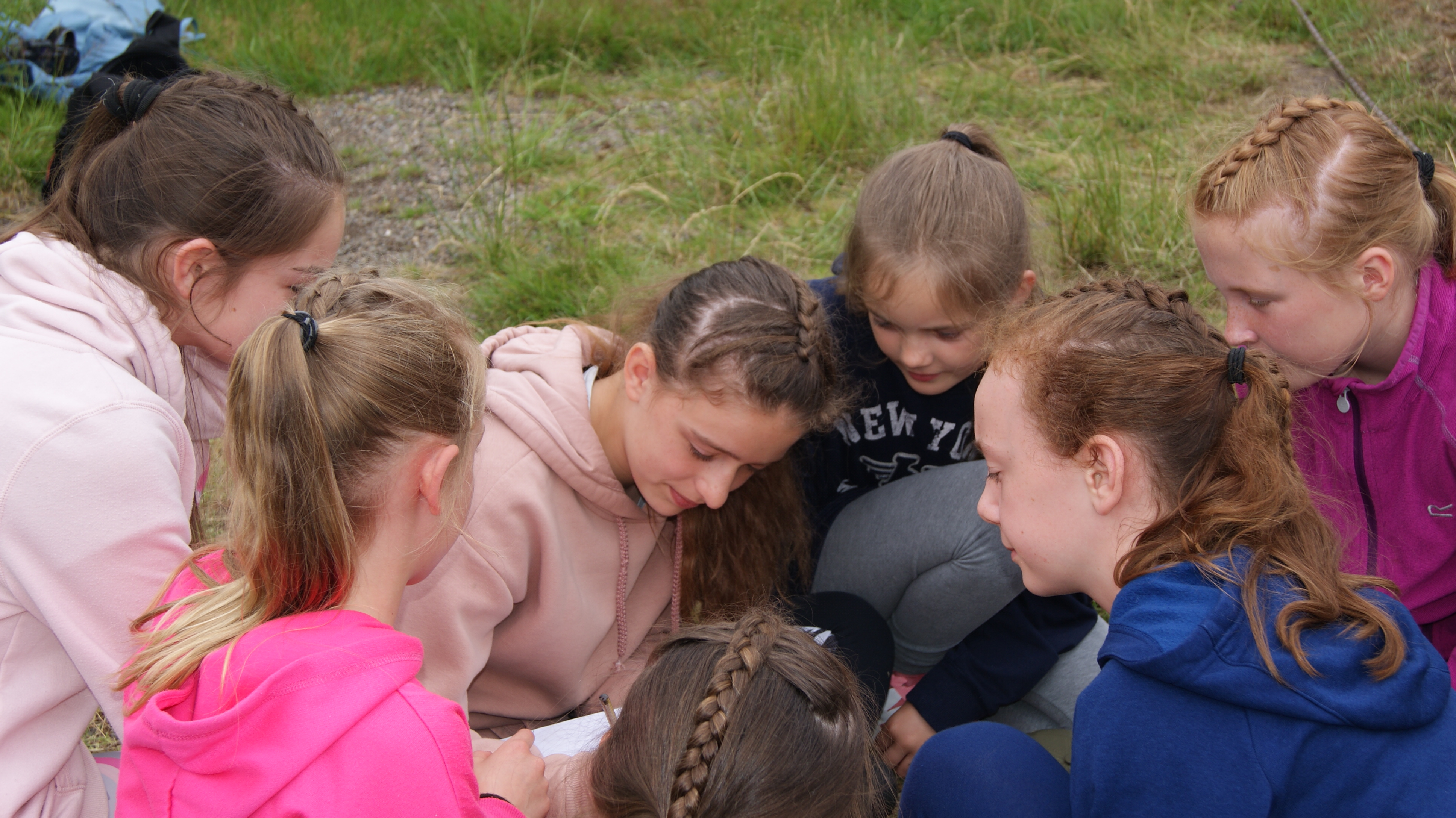Girls group huddled recording data