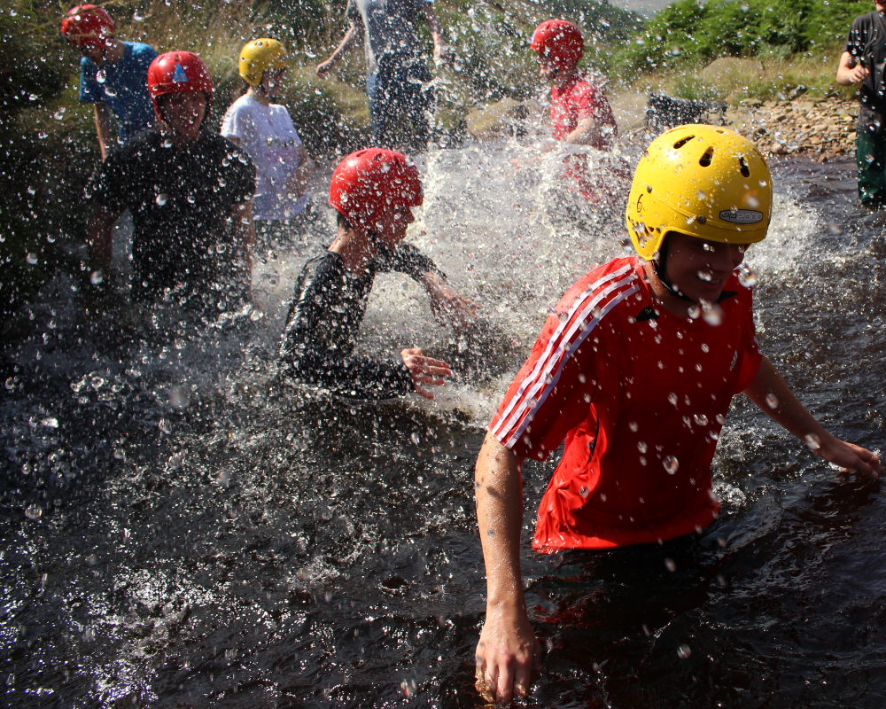 Youth groups wading through water